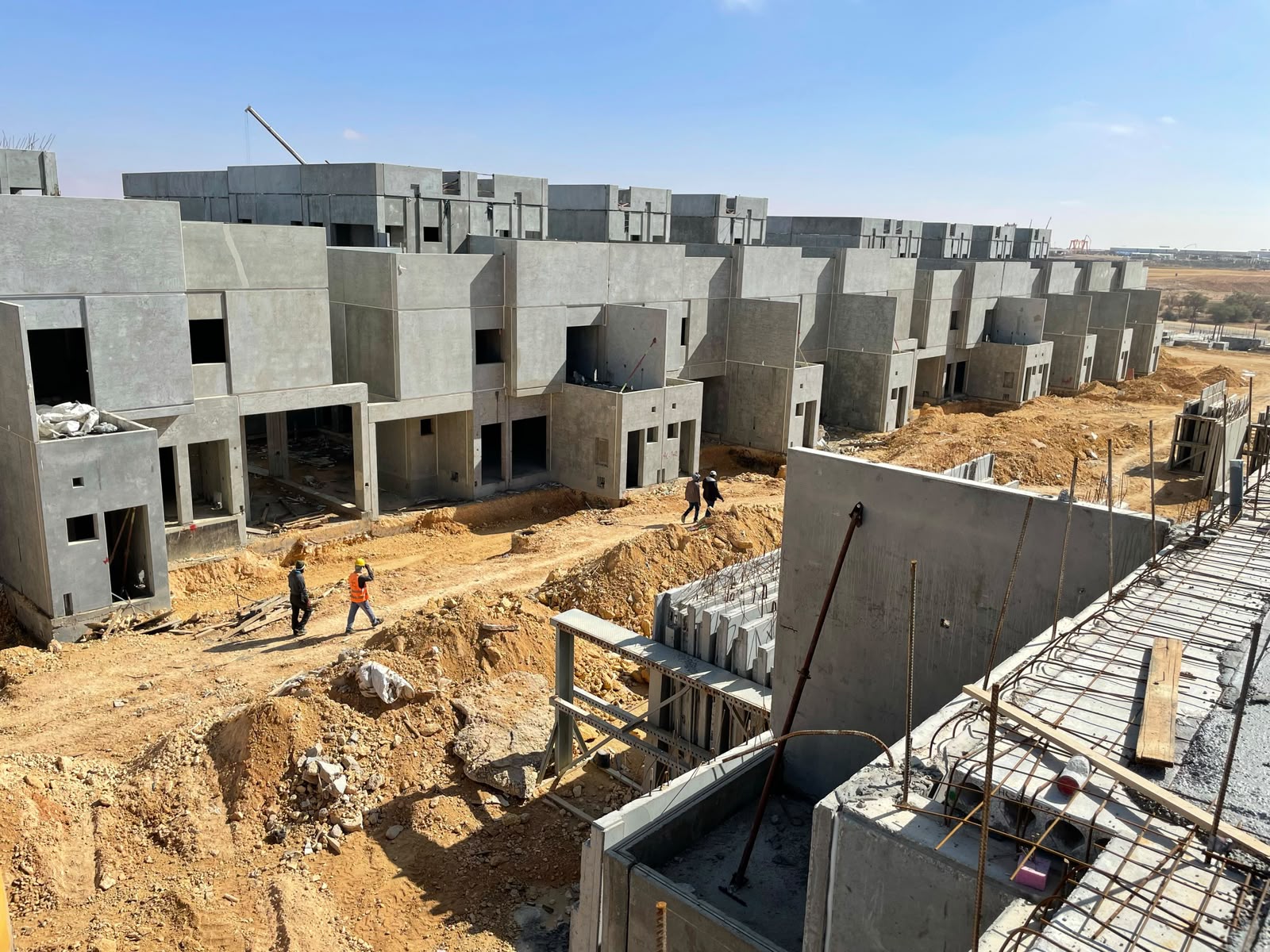 Row of precast villa shells at structural completion